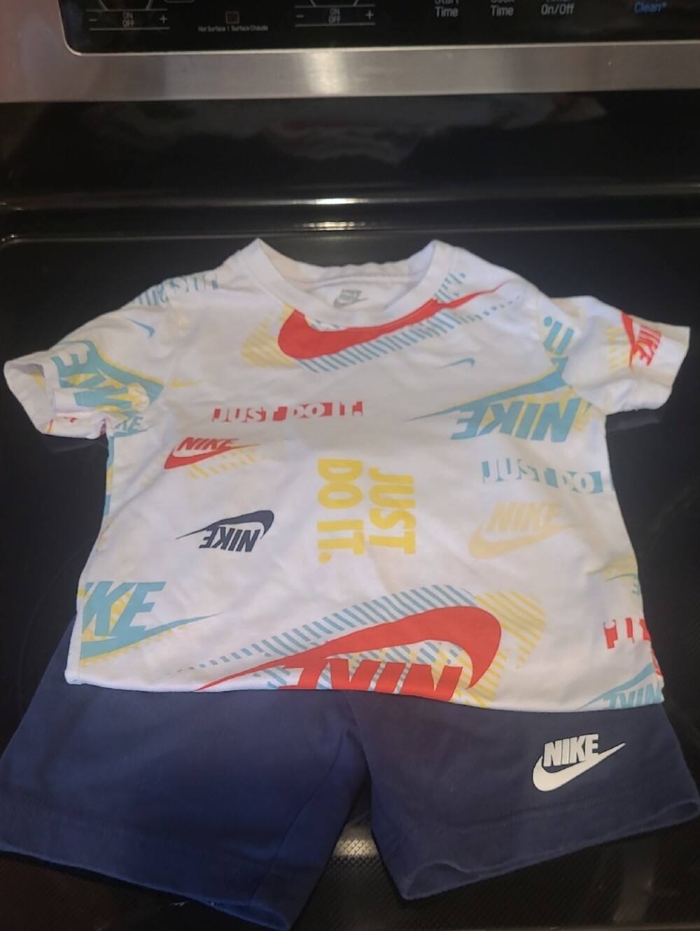 Nike White Tee with Red, Yellow, Blue & Teal Graphic Logos
